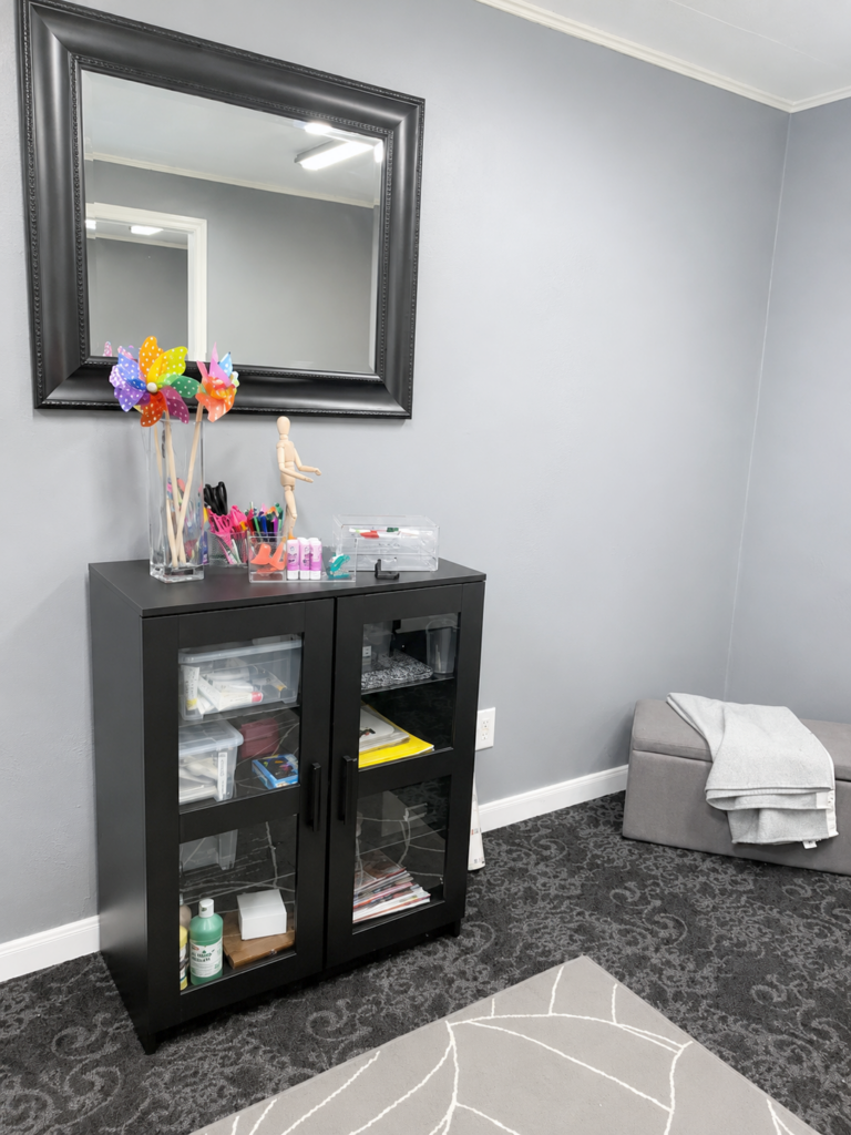 Art supply cabinet and framed mirror in the MBHI therapy office
