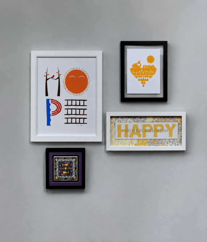 Gallery wall with colorful framed artwork and a HAPPY print at MBHI